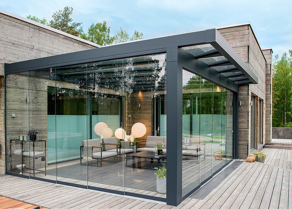Premium glass room with chandelier-style lighting at a modern wood-clad home