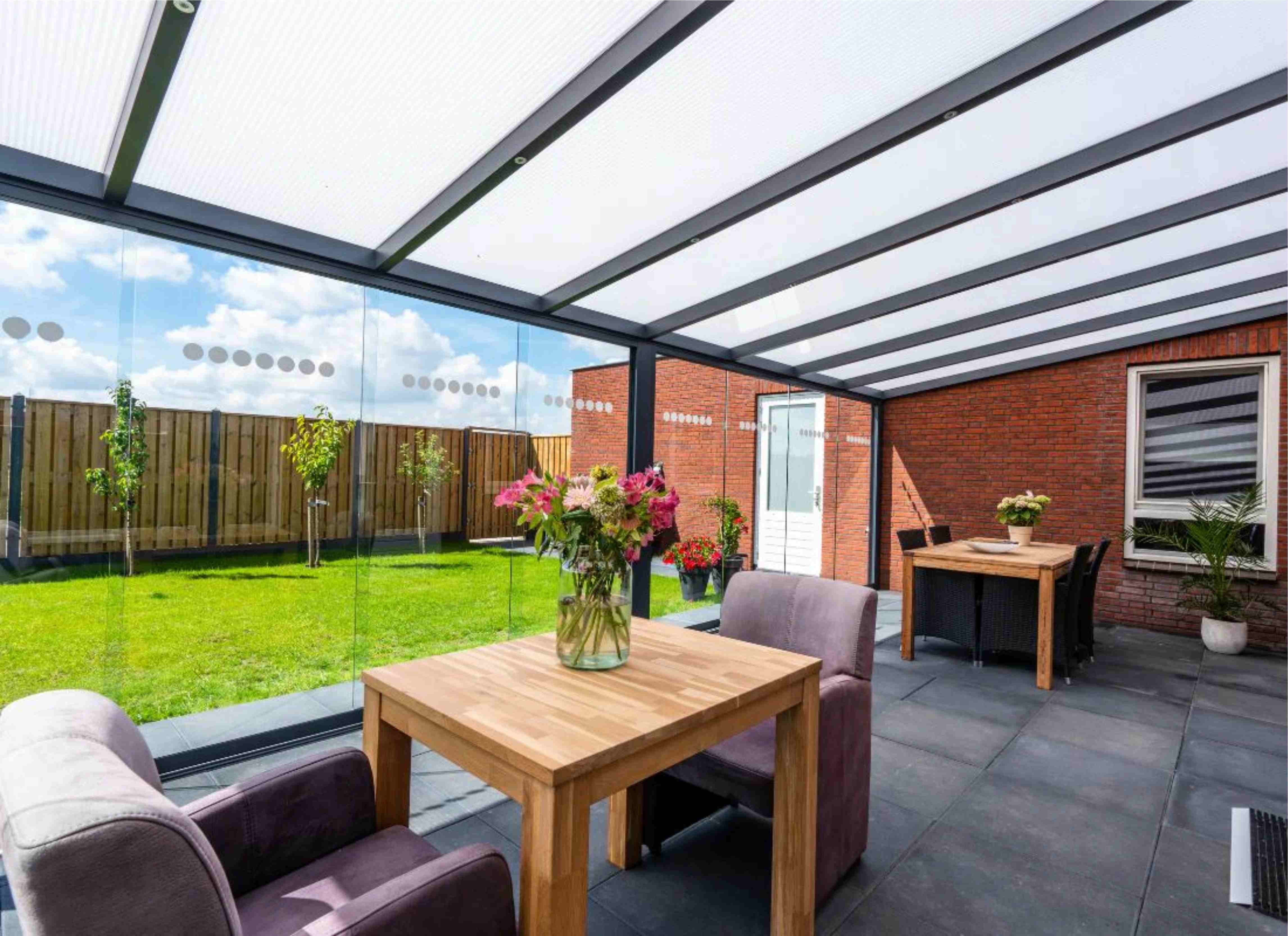 Sliding glass walls enclosing a veranda, looking out to the garden